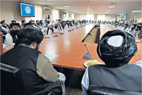  ??  ?? Sirajuddin Haqqani (left), the Taliban’s deputy leader with a $10 million US bounty offered for his capture, chairs an introducto­ry meeting as new minister of the interior