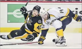  ?? Keith Srakocic Associated Press ?? THE PITTSBURGH PENGUINS’ Conor Sheary, left, is checked to the ice by defenseman Mattias Ekholm of the Nashville Predators during the second period.