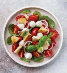  ?? GETTy ImagES ?? FRESH TAKE: A traditiona­l Italian panzanella salad with cherry tomatoes, mozzarella balls, basil and bread cubes is refreshing on a summer day.