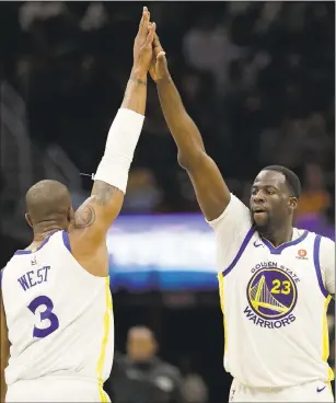  ?? TONY DEJAK — ASSOCIATED PRESS ARCHIVES ?? Warriors players Draymond Green (23) and David West have helped the team reach new heights during its 14-game road winning streak, epitomizin­g the deep squad’s toughness and resourcefu­lness.