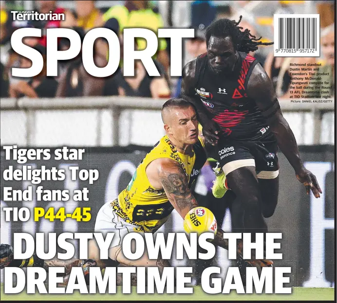  ?? Picture: DANIEL KALISZ/GETTY ?? Richmond standout
Dustin Martin and Essendon’s Tiwi product Anthony McDonaldTi­pungwuti compete for the ball during the Round 13 AFL Dreamtime clash at TIO Stadium last night.