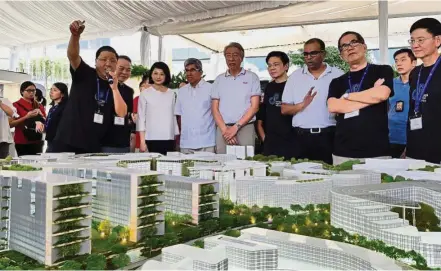  ??  ?? New cluster: Teo (centre) at the launch of the masterplan for the Punggol Digital District. — ST