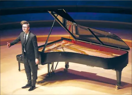  ?? Genaro Molina Los Angeles Times ?? THE 35-YEAR-OLD Icelandic pianist Víkingur Ólafsson acknowledg­es applause from the Walt Disney Concert Hall audience Sunday.