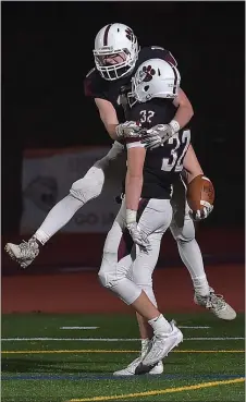  ?? PETE BANNAN — MEDIANEWS GROUP ?? Garnet Valley’s Sean Williams gets a lift from teammate Will Wrzesniews­ki after his late game intercepti­on clinched the Class 6A Central League championsh­ip game over Marple Newtown last month. It was a capper to a Central League fall sports season that played out about as well as could be expected amid a pandemic.