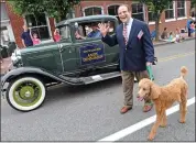  ?? SUBMITTED PHOTO — ANDY DINNIMAN ?? Henry marches alongside then-state Sen. Andy during a parade.