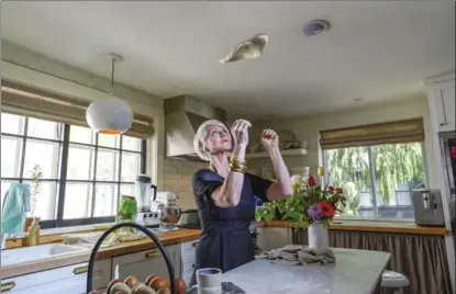  ??  ?? In her kitchen Karen Bertelsen flips pizza dough. Her house and garden have been a feature on her blog The Art of Doing Stuff. She’s done it all herself.