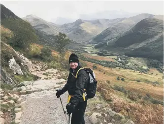  ??  ?? Alan Beck while climbing Ben Nevis.