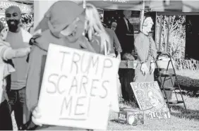  ?? Andrew Harnik / Associated Press ?? Activists, some in Halloween costumes, gather on Oct. 9 in St. Louis before the second presidenti­al debate. Observers say this election cycle has lost the decorum and policy-driven debate that marked elections of the past.