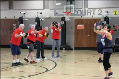  ?? The Sentinel-Record/Tanner Newton ?? FIGHTING BACK: FBC Fitness Director Amy Johnson leads a Rock Steady Boxing class at First Baptist Church recently. RSB is a boxing-based workout group for people with Parkinson’s disease.