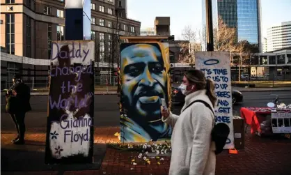  ?? Photograph: Chandan Khanna/AFP/Getty Images ?? A painting of George Floyd is seen outside the Hennepin county government center in Minneapoli­s, Minnesota.