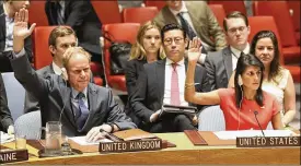  ?? MARY ALTAFFER / AP ?? U.N. ambassador­s Matthew Rycroft (left) of Great Britain and Nikki Haley of the U.S. vote during a Security Council meeting on a new sanctions resolution that would increase pressure on North Korea on Saturday at U.N. headquarte­rs.