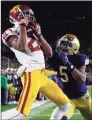  ?? Paul Sancya / Associated Press ?? USC receiver Tyler Vaughns, left, catches a 5-yard touchdown pass against Notre Dame in South Bend, Ind., in 2019. USC and Notre Dame renew their storied rivalry in South Bend on Oct. 23.
