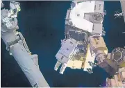  ?? NASA VIA AP ?? Astronaut Peggy Whitson takes a spacewalk outside the Internatio­nal Space Station Friday to install new lithium-ion batteries.