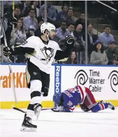  ?? BRUCE BENNETT / GETTY IMAGES ?? Kris Letang of the Pittsburgh Penguins celebrates his empty-net goal at 19:47 of the third period.