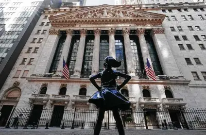  ?? Mary Altaffer / Associated Press ?? The Fearless Girl statue stands in front of the New York Stock Exchange in that city’s Financial District.