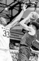  ?? LANGSTON | AP JACOB M. ?? Kansas forward David McCormack, left, and Kansas guard Ochai Agbaji defend as Dayton forward Toumani Camara shoots during the first half in Lake Buena Vista.