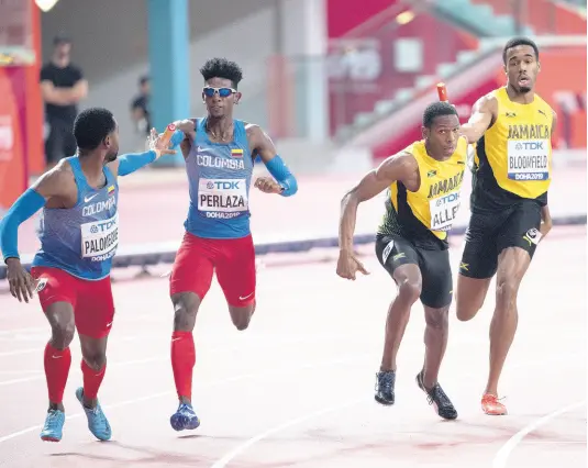  ?? FILE ?? Jamaica’s Nathon Allen collects the baton from teammate Akeem Bloomfield in the first exchange of the men’s 4x400m relay final at the World Athletics Championsh­ips in Doha, Qatar on Sunday, October 6, 2019. Jamaica Athletics Administra­tive Associatio­n Honorary Secretary hopeful Anthony Davis says, if successful in his bid for the role, he will seek to have more athletes join the body as members.