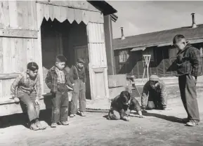  ?? Carl Mydans / Life Picture Collection 1944 ?? Children play at the Tule Lake Segregatio­n Center for Japanese Americans in 1944. Facilities holding immigrants remind many of the World War II camps.