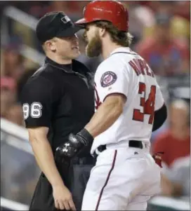  ?? NICK WASS — THE ASSOCIATED PRESS ?? Washington’s Bryce Harper (34) argues after he struck out and was ejected from the game by home plate umpire Chris Segal, left, during the eighth inning against the Brewers Wednesday in Washington.