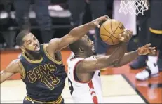  ??  ?? Cavaliers center Tristan Thompson left, blocks Raptors forward Serge Ibaka on Friday in Toronto.