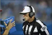  ?? MIKE MCCARN — THE ASSOCIATED PRESS ?? Referee Tony Corrente (99) looks at the instant replay on a Microsoft Surface tablet during a preseason game between the Panthers and the Texans in Charlotte, N.C.