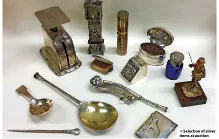  ?? ?? > Selection of silver items at auction