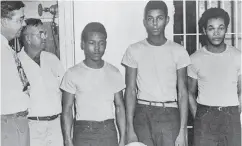  ?? STATE LIBRARY AND ARCHIVES OF FLORIDA VIA THE ASSOCIATED PRESS ?? Lake County Sheriff Willis McCall, far left, and an unidentifi­ed man stand next to, from left, Walter Irvin, Samuel Shepherd and Charles Greenlee, charged with another man in connection with a 1949 rape in Florida.