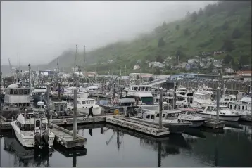  ?? JOSHUA A. BICKEL — THE ASSOCIATED PRESS FILE ?? A person walks across the dock at St. Paul Harbor on June 22in Kodiak, Alaska.