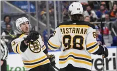  ?? FRANK FRANKLIN II — THE ASSOCIATED PRESS ?? Bruins forward Brad Marchand, left, celebrates with David Pastrnak after scoring against the Islanders on Jan. 18.