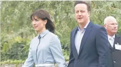  ?? — Reuters photo ?? Cameron and his wife Samantha arrive to vote at a polling station in Spelsbury, central England, Britain.