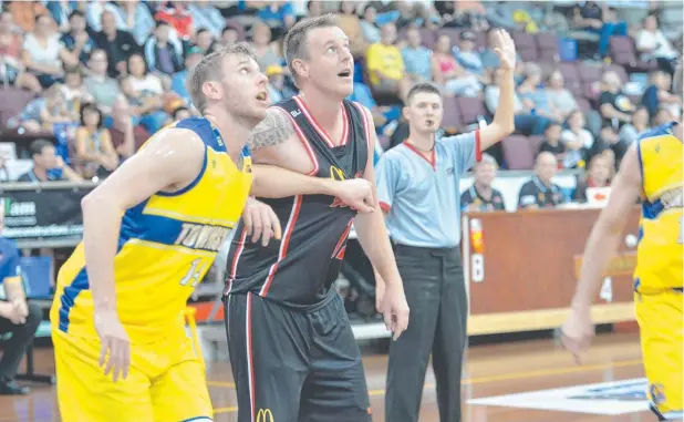  ??  ?? HOOP DREAMS: Townsville Heat forward Matt Rees boxing out Mackay Meteors player-coach Cameron Tragardh last weekend.