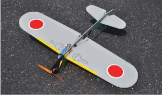  ??  ?? Bottom view of completed airplane and aileron servo installati­on. The receiver and speed control are held in place with Velcro, the LiPo battery pack is mounted with Velcro plus a strap going through slots in the fuselage, for security.