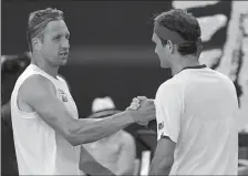  ?? LEE JIN-MAN/AP PHOTO ?? Roger Federer, right, is congratula­ted by Tennys Sandgren after winning their quarterfin­al match at the Australian Open on Tuesday.