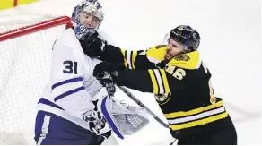  ??  ?? Bruins centre David Krejci pops Toronto goaltender Frederik Andersen in the face during Game 7 at Boston’s TD Garden arena Wednesday.