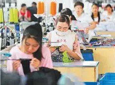  ?? AFP ?? Employees make socks for export at a factory in eastern China. Beijing has warned it would retaliate in kind after the US president threatened to impose fresh tariffs.