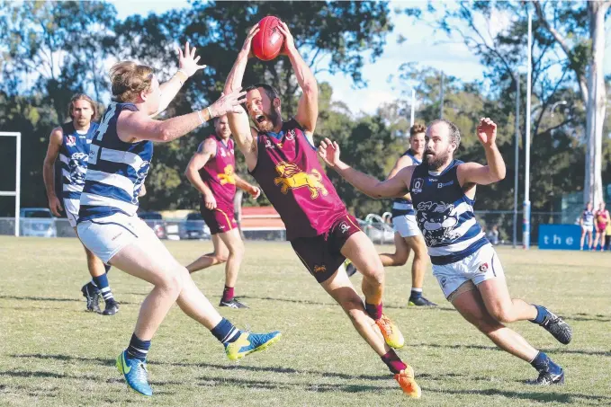  ??  ?? Palm Beach-Currumbin’s Jake Dignan tries to navigate his way through the swarm of Broadbeach defenders in Saturday’s QAFL match at Salk Oval. Picture: RICHARD GOSLING