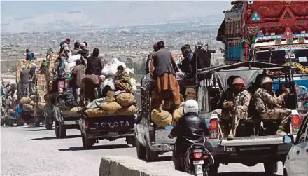  ?? AFP PIC ?? Pakistani paramilita­ry soldiers escorting vehicles carrying Shia Hazara minority traders and their fruit and vegetables on the way back from a market to a heavily guarded enclave where they live on the outskirts of Quetta last month.