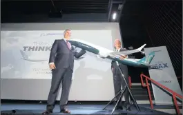  ??  ?? Kevin McAllister, the chief executive of commercial aircraft at Boeing, left, and chief executive officer Dennis Muilenburg with a model of a Boeing 737 Max 10 passenger jet during a news conference at the Internatio­nal Paris Air Show. Photo: Bloomberg