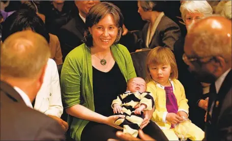  ?? Chip Somodevill­a Getty Images ?? ANN O’LEARY, shown in 2010 holding her infant son, is an attorney and veteran political aide with a reputation as a coalition builder.