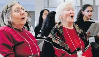  ??  ?? Mary Peters, left, and Rita Goodman are among 60 members of the choir, which includes people living with dementia, their caregivers and high school students.