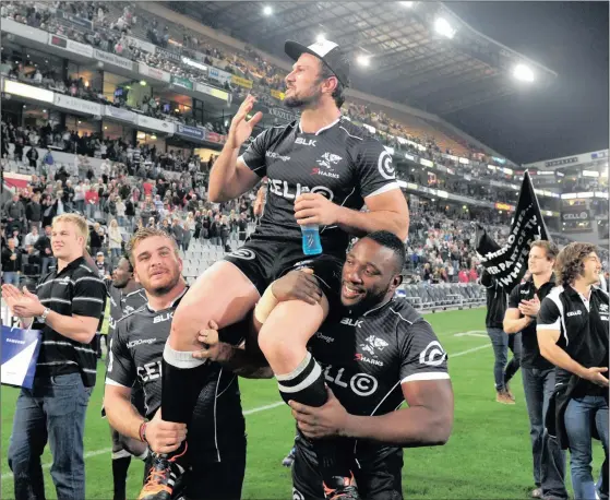  ?? Picture: GERHARD DURAAN/BACKPAGEPI­X ?? GOODBYE TO A BIG SHARK: on Saturday night.
Tendai Mtawarira and Dale Chadwick carry Springbok and Sharks hooker Bismarck du Plessis around the field for his lap of honour after his final game for the Sharks