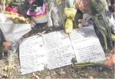  ??  ?? A tribute listing the victims of the mosque attacks is placed at a memorial site in Christchur­ch. — AFP photo