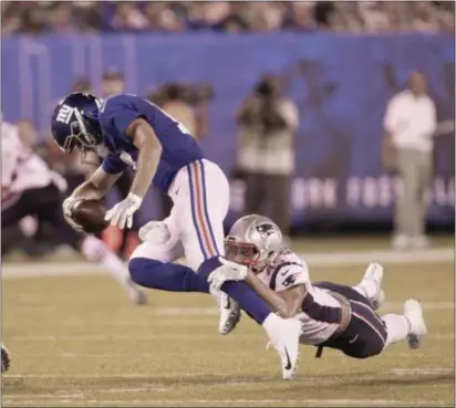  ?? JOHN BLAINE — FOR THE TRENTONIAN ?? Giants quarterbac­k Kyle Lauletta is sacked by Patriots’ Trent Harris during a preseason game in August.