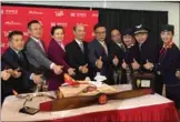  ?? LIA ZHU / CHINA DAILY ?? Luo Linquan (fourth from left), Chinese consul general in San Francisco, and Hou Wei (to right of Luo), senior vice-president of Hainan Airlines, join the inaugural flight crew to celebrate the launch of the first direct flight between Las Vegas and...