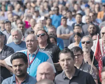  ?? CHRIS YOUNG/THE CANADIAN PRESS ?? Workers at a Bombardier plant in Toronto listen to Unifor national president Jerry Dias speak Wednesday amid mounting calls for Boeing to drop a trade complaint against Bombardier. Bombardier rejected claims that it is not co-operating with the probe.