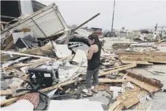  ??  ?? 0 Jennifer Bryant looks over the wreckage after her family business in Katy, Texas, was destroyed by Hurricane Harvey