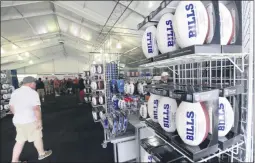  ?? THE ASSOCIATED PRESS ?? FILE - In this July 27, 2017, file photo, fans shop in the merchandis­e tent on opening day of Buffalo Bills NFL football training camp in Pittsford, N.Y.