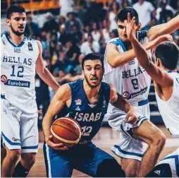  ?? (FIBA Europe) ?? ISRAEL GUARD Tamir Blatt (center) was shut down by the Greek defense in last night’s 65-56 loss to the hosts in the final of the under-20 European Championsh­ip.