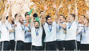  ??  ?? Germany celebrate with the trophy after winning the FIFA Confederat­ions Cup against Chile at Saint Petersburg Stadium in St. Petersburg, Russia. — Reuters photo