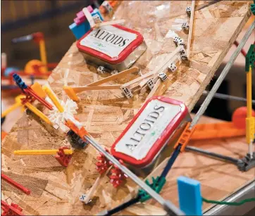  ?? RANDY VAZQUEZ — STAFF PHOTOGRAPH­ER ?? Altoids tins and small dice are used on a Rube Goldberg machine being assembled at The Tech in San Jose on Wednesday.